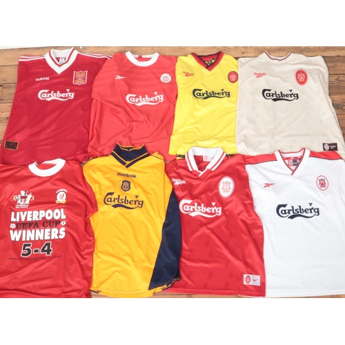 180 - Two boxes of early 2000s Liverpool FC football programmes along with eight Liverpool FC football shi... 