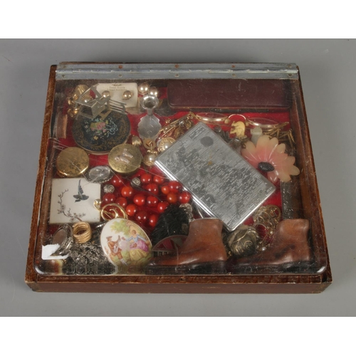 45 - A small tabletop bijouterie case with contents of assorted costume jewellery and collectables. To in... 