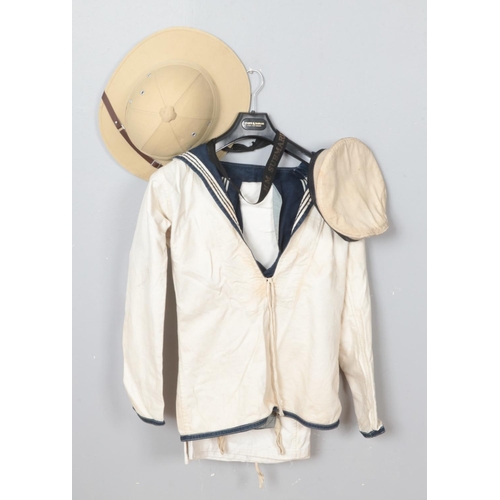 234 - A vintage sailor uniform, including shirt, vest, trousers and cap. Also including pith helmet.