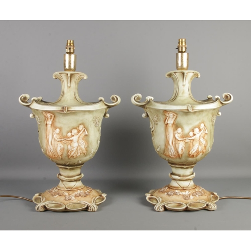 237 - A large pair of Florence ceramic table lamps, formed as twin handled urns with figures to the front,... 