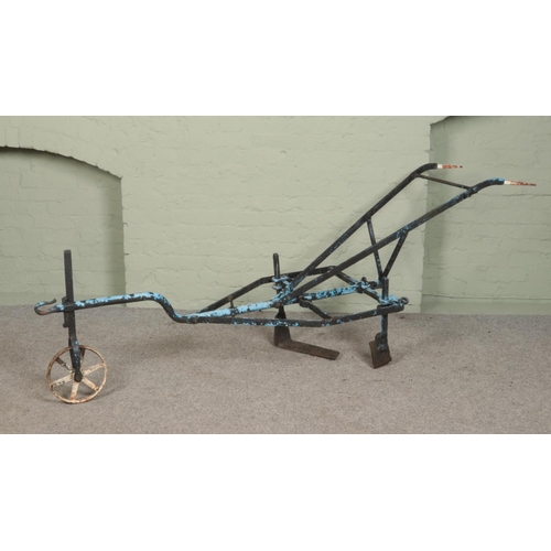 243 - An antique iron two handle plough. Approximate length 240cm.