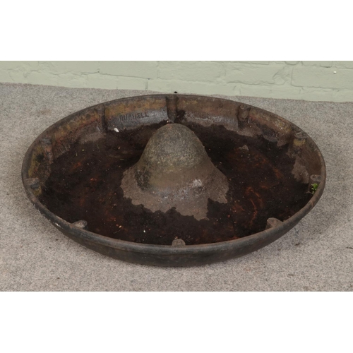 247 - A vintage cast iron Mexican hat shaped trough. Diameter 90cm.