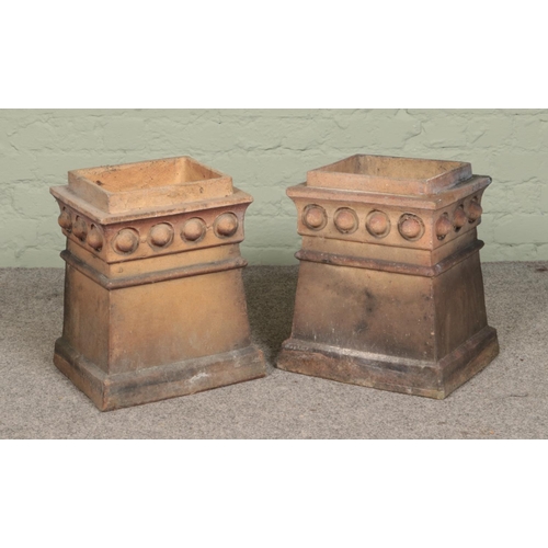 249 - A near pair of terracotta chimney pots of rectangular form with beaded decoration. Height 45cm (both... 