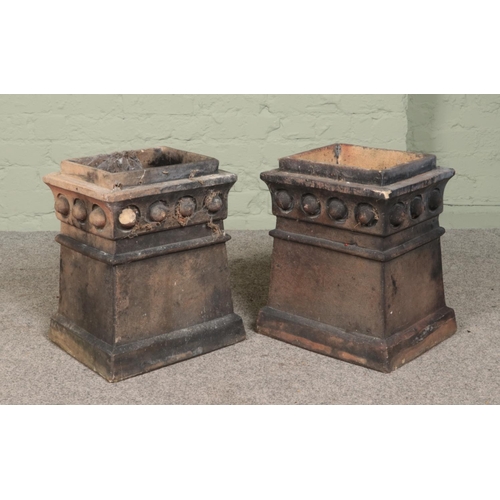 251 - A pair of terracotta chimney pots of rectangular form with beaded decoration. Height 45cm (both), Wi... 