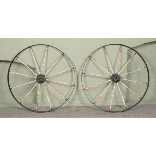 252 - A pair of antique painted iron cart wheels. Diameter 122cm.