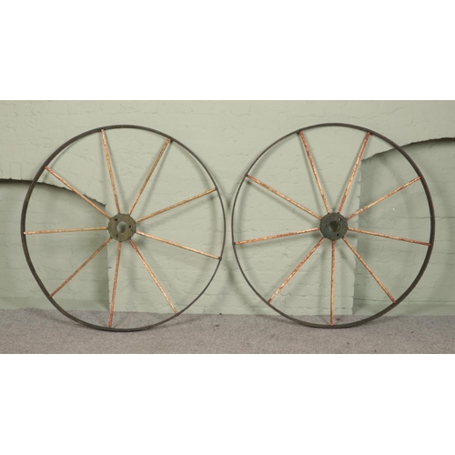 253 - A pair of antique painted iron cart wheels by Blackstone & Co Stamford. Diameter 122cm.