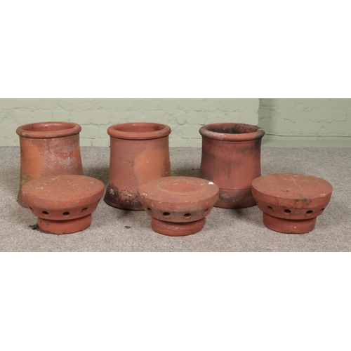 254 - Three small terracotta chimney pots, all having pepper pot style cowls/flues. All approximately 39cm... 