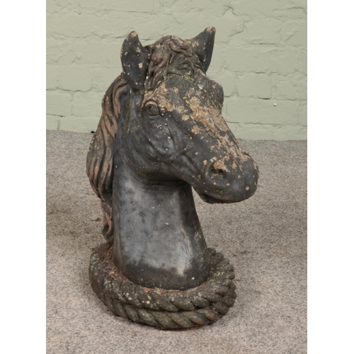 256 - A cast concrete model of a horses head. Height 49cm.