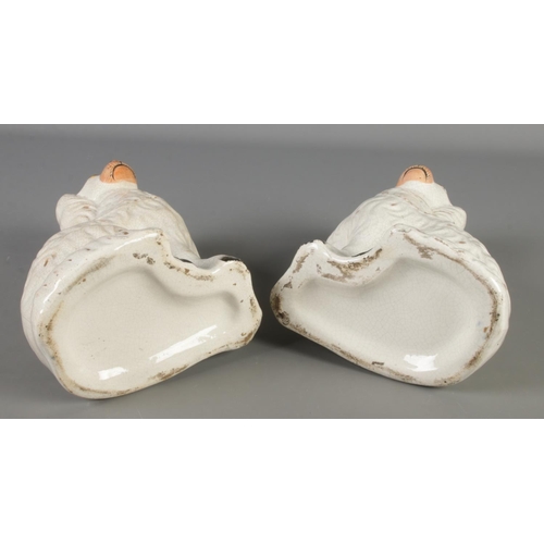 6 - A pair of Victorian Staffordshire pottery mantel dogs. Height 23cm.