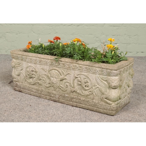 259 - A rectangular cast concrete planter decorated with mythical creatures. Height 26.5cm, Length 73cm, D... 