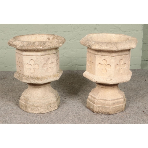 267 - A pair of cast concrete octagonal garden urns with Gothic 'cloverleaf' / quatrefoil decoration. Heig... 