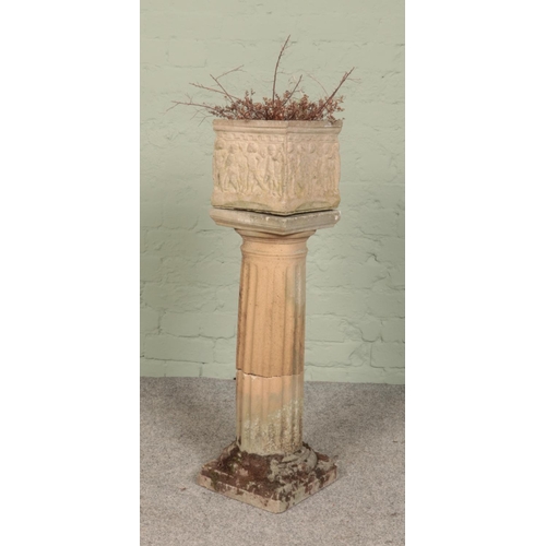 270 - A Corinthian style garden pillar, with square foot and base, with a small cube garden planter depict... 