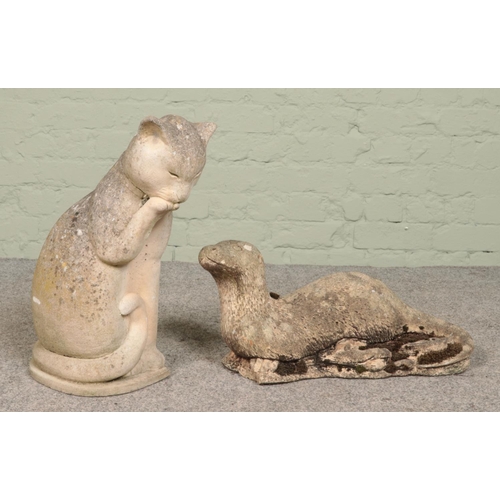 272 - Two concrete garden animals; otter and cat.