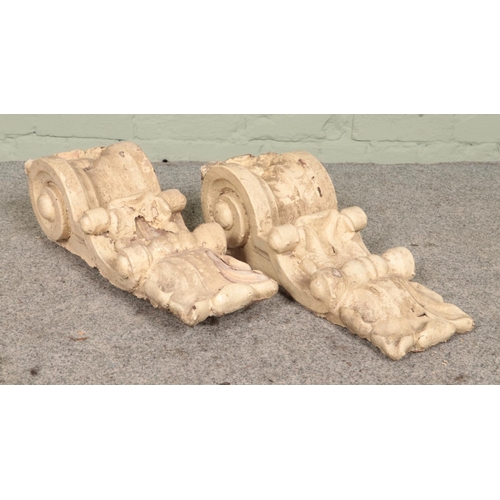 273 - A pair of garden wall corbels, previously painted, with scrolled decoration. Height: 49cm.