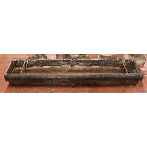 282 - A very large cast iron garden trough, with central tie ring and roll top to one side. Length: 183cm.