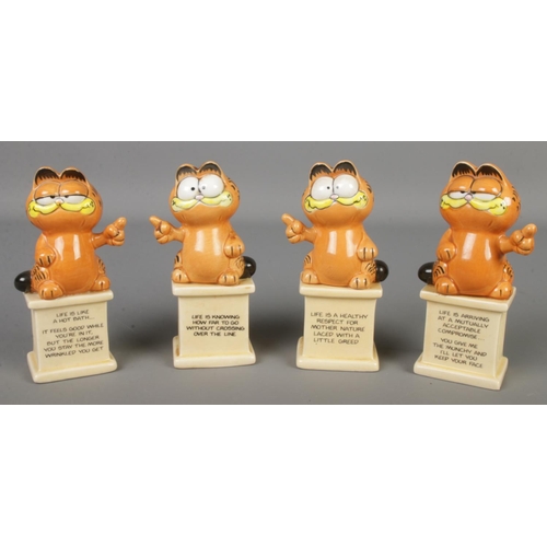 64 - Four ceramic Garfield figures.