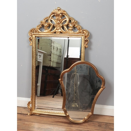 311 - An ornate gilt framed bevel edge wall mirror along with a smaller example. Largest 100cm x 57cm.