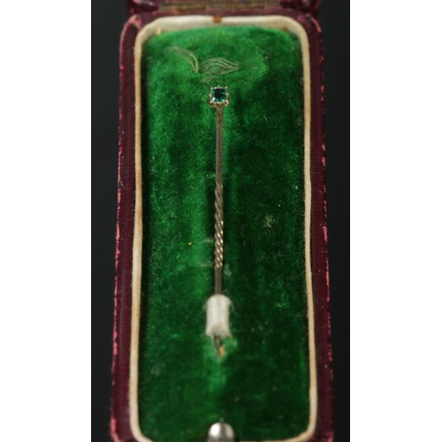 330 - A Gold and Emerald stick pin, with part twisted stem. 47mm long. Size of stone 3mm. Total weight: 0.... 