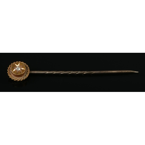 331 - A 15ct Gold and Diamond stick pin, with rope twist border and stone set in star mount. 50mm long. To... 