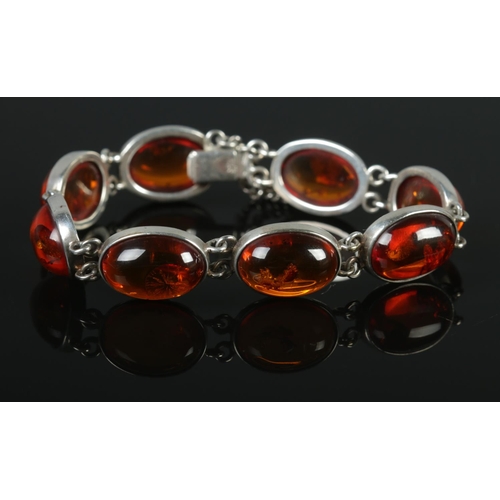 333 - A silver and amber/copal bracelet, stamped 925 with makers mark DPA. Total weight: 23.5g.