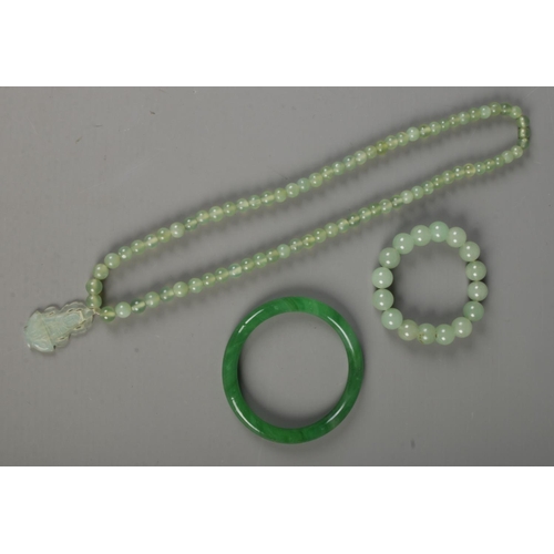 349 - Three pieces of jade jewellery. Includes bead necklace with pendant, bead bracelet and bangle.