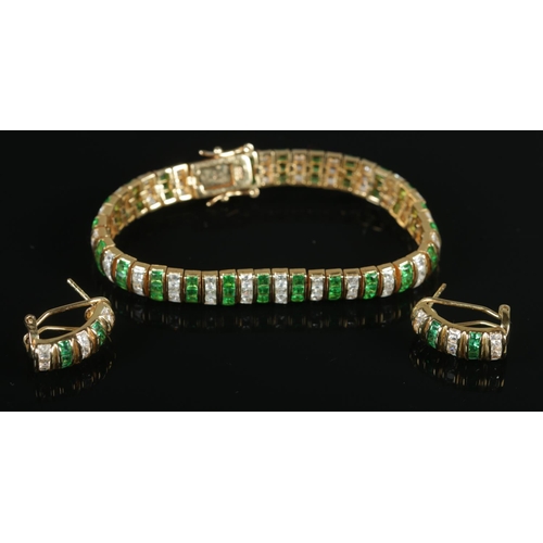 351 - A silver gilt bracelet and matching earrings. Set with coloured and clear paste stones.