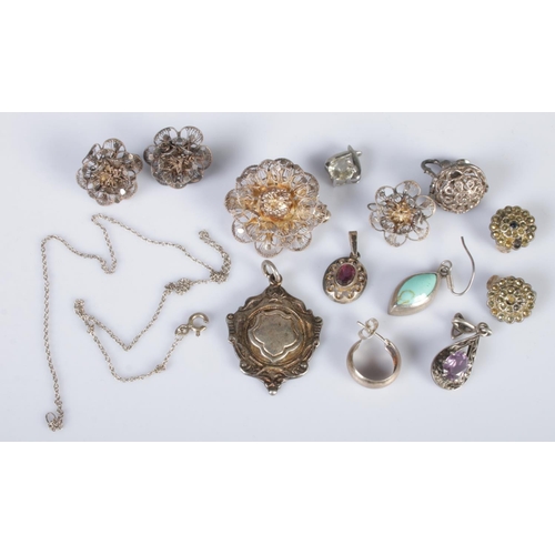 363 - A quantity of silver and white metal. Includes white metal fob, pendants, filigree brooch and screw ... 