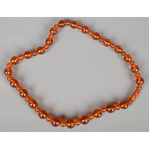 378 - An amber bead necklace. 64g.