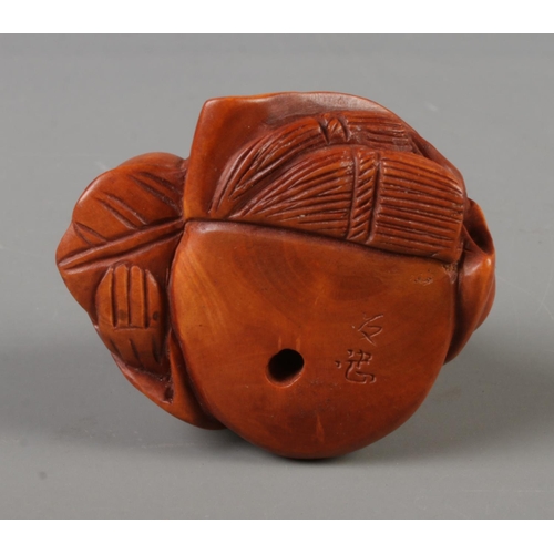 384 - A Japanese carved Netsuke in the form of the god of longevity, signed to base.