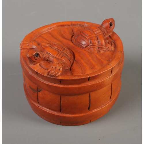 386 - A Japanese carved Netsuke in the form of two turtles in a barrel .