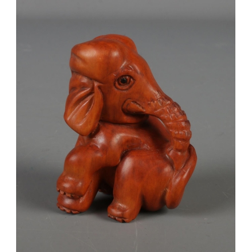 388 - A Japanese carved Netsuke in the form of a elephant.