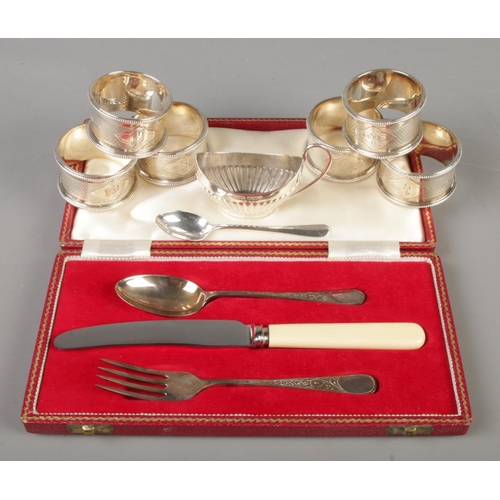 405 - A collection of silver. Includes a set of six Walker & Hall napkin rings, cased three piece set, sil... 