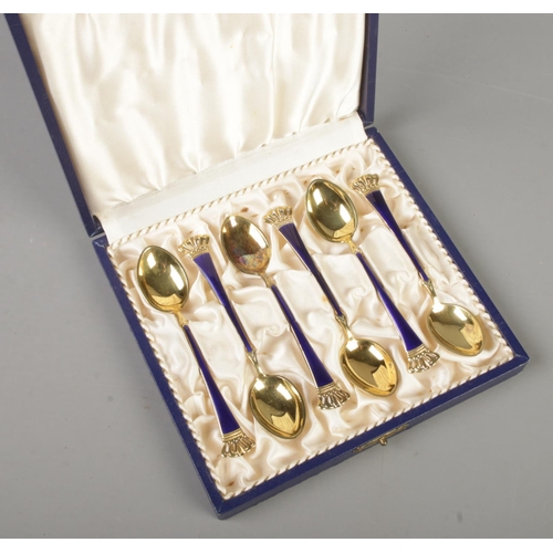 406 - A set of six vintage Danish silver gilt demitasse spoons with enamel decoration and crown terminals.... 