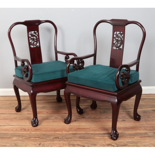 413 - A set of ten Chinese hardwood dining chairs, with carved detailing, pierced splat depicting a dragon... 