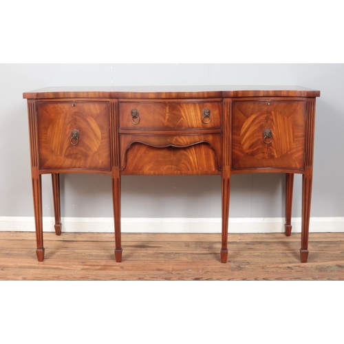 418 - A Regency style mahogany serpentine front sideboard, with central drawers flanked by cupboard doors.... 