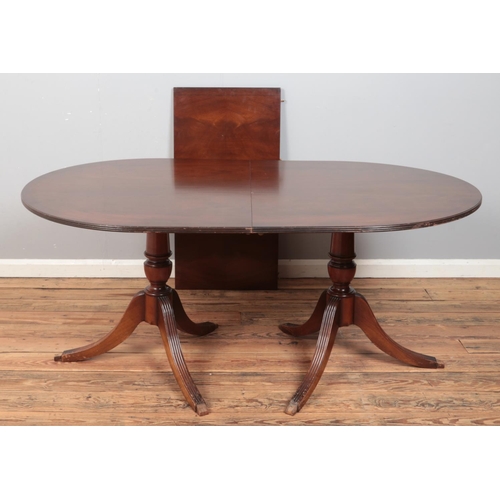 419 - A mahogany twin pedestal extending dining table, with additional leaf and six wheat back dining chai... 