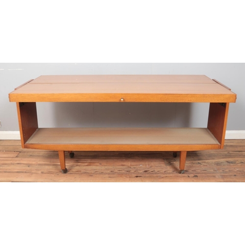 421 - A Formica metamorphic sideboard/table. Raised on casters. Height: 74cm, Width: 159cm, Depth (as a si... 