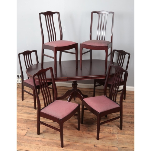 428 - A Stag centre pedestal extending dining table and six matching dining chairs. (77cm x 135cm x 92cm) ... 