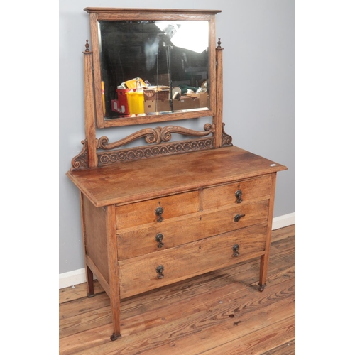 429 - A carved oak dressing table with scrolling decoration. (160cm x 110cm)