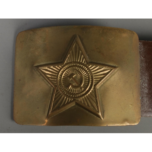 139 - A WWII Russian brass belt buckle. Soviet red star with hammer and sickle to the centre.