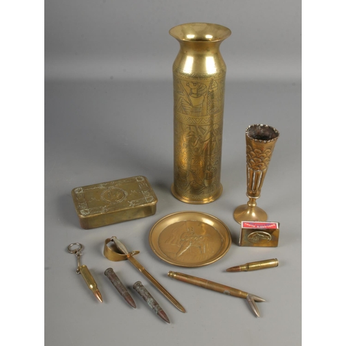 147 - A collection of trench art and military themes brassware including artillery shell, match box holder... 