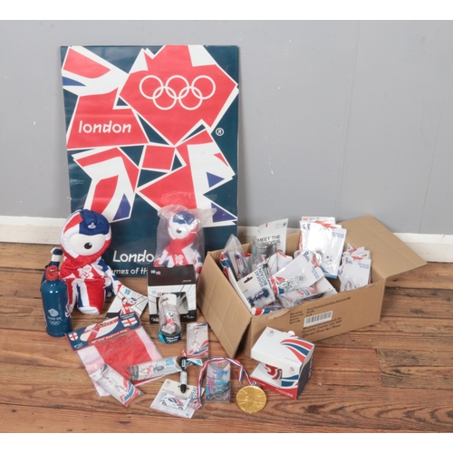 215 - A box of assorted London 2012 Olympics memorabilia. Includes poster, mugs, key rings, back pack etc.