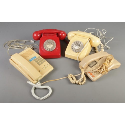 216 - Four vintage telephones including two rotary dial examples.