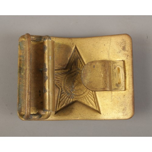 139 - A WWII Russian brass belt buckle. Soviet red star with hammer and sickle to the centre.