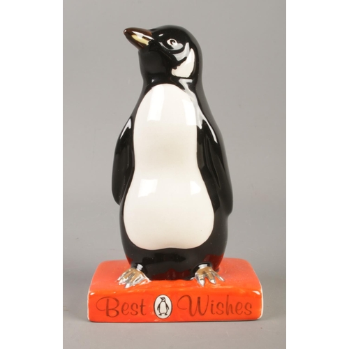 381 - A Royal Doulton for Penguin books figure modelled as penguin standing upon a book titled 'Best Wishe... 