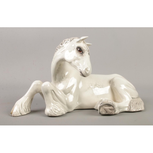 383 - A Beswick figure modelled as a lying dapple grey shire horse. Approx. height 13cm.