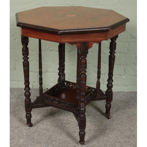 410 - A walnut and rosewood octagonal window table with fan patera.