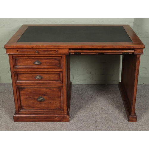 415 - A stained pine kneehole desk with leather inset top.