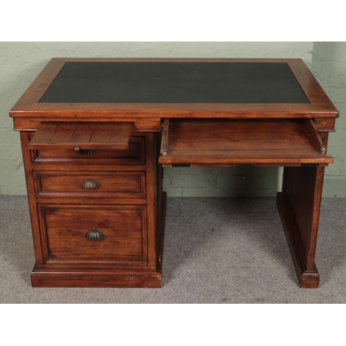 415 - A stained pine kneehole desk with leather inset top.