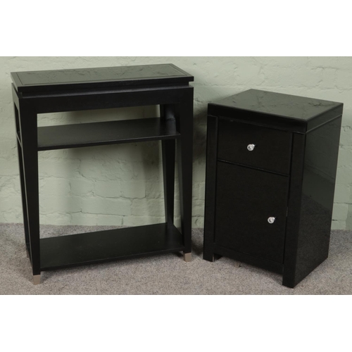 416 - A black glass cabinet along with matching side table. (Side table 77cm x 64cm)